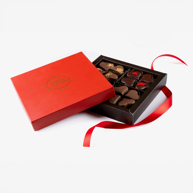Open red chocolate box with a ribbon on a white background