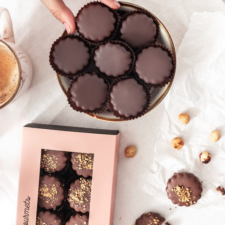 Handcrafted Sablés displayed on a white ceramic plate, ideal for luxury gifting and indulgence