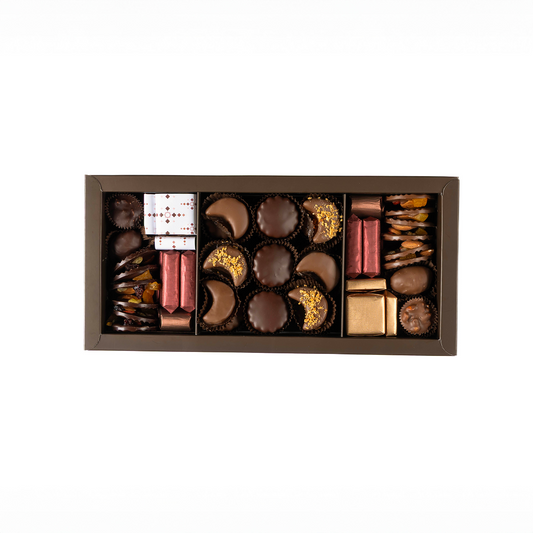Assorted chocolates in a decorative box on a white background