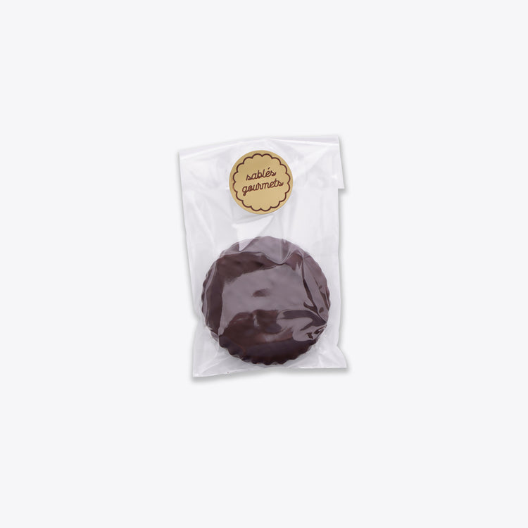 Close-up of a luxurious dark chocolate Sablé, handcrafted to perfection