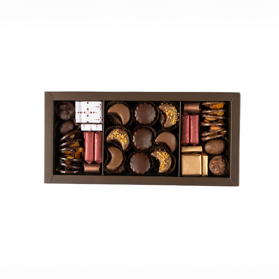 Assorted chocolates in a decorative box on a white background
