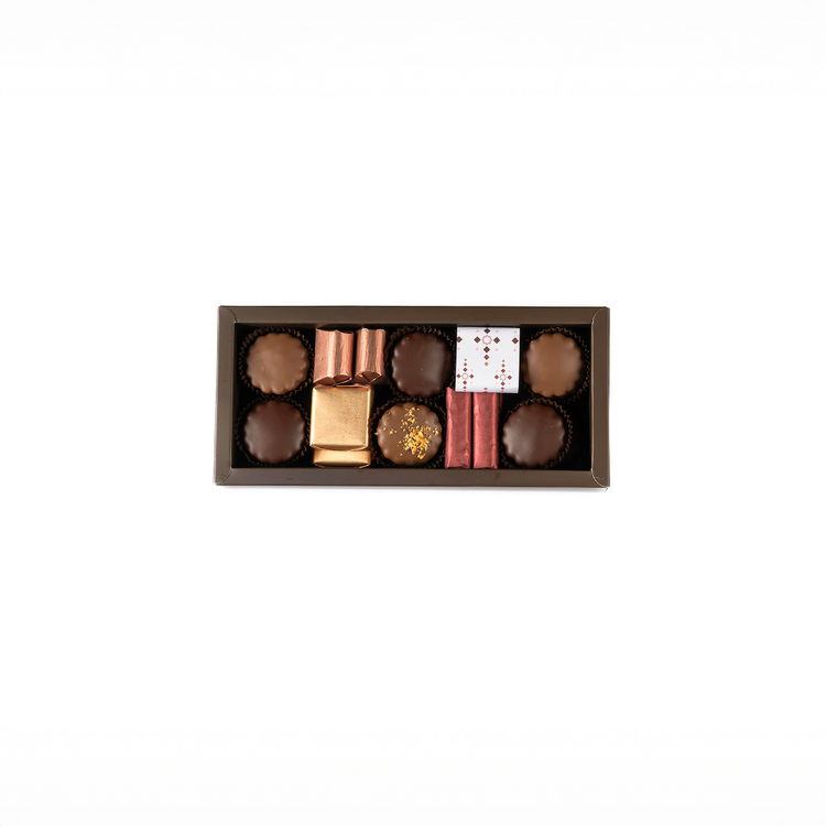 Assorted chocolates in a decorative box on a white background