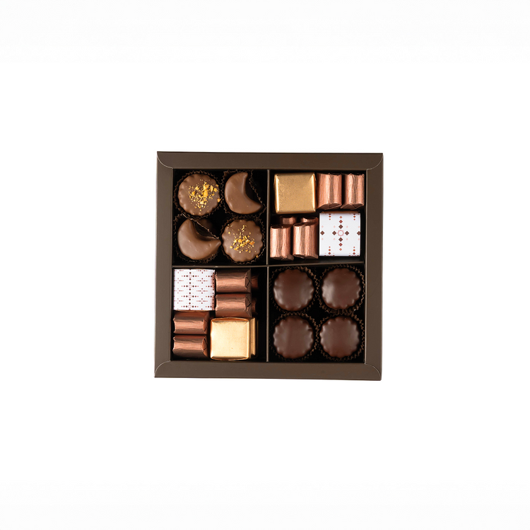 Assorted chocolates in a decorative box on a white background
