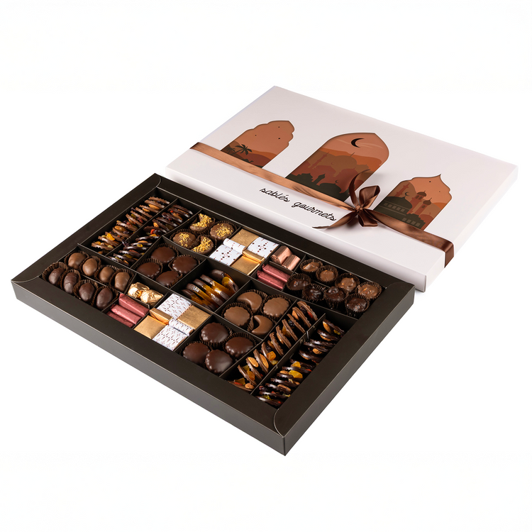 Assorted chocolates in a decorative box with a branded lid on a white background
