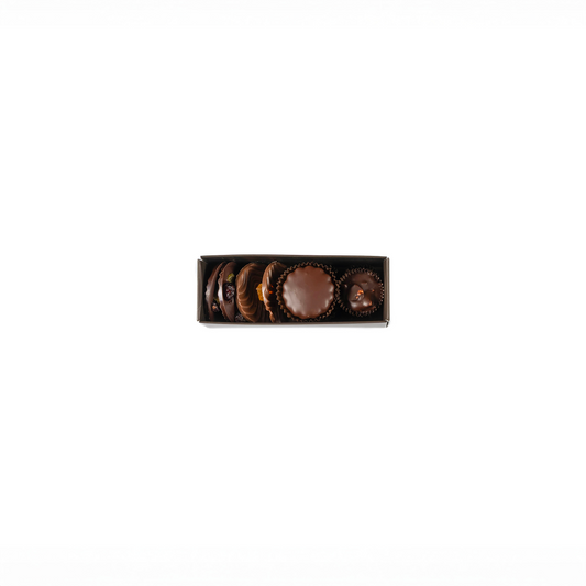 Set of chocolate truffles in a decorative box on a white background