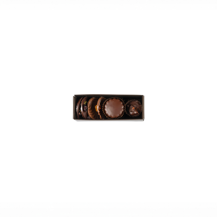 Set of chocolate truffles in a decorative box on a white background