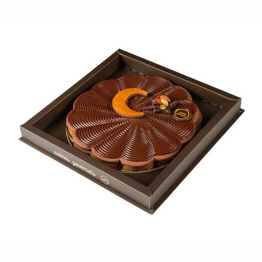 Chocolate tart in a decorative box on a white background