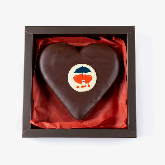 Chocolate heart with a logo in a box on a white background