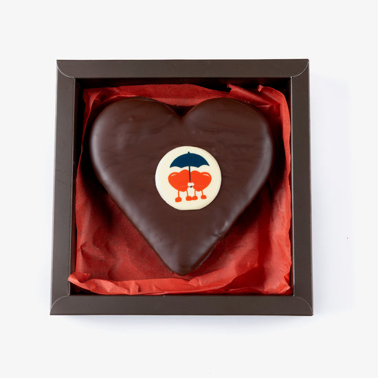 Chocolate heart with a logo in a box on a white background